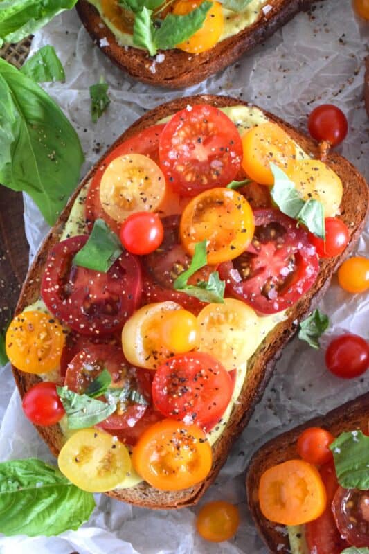 There is nothing in the world as delicious as a Toasted Tomato Sandwich prepared with locally grown, in-season, fresh tomatoes. It's a classic, and one that many of us can remember from the summers of our childhood. This version is simple and easy, but with a few surprise ingredients to increase the yum factor. #toasted #tomato #sandwich #tomatoes #summerfresh #local #sandwiches #classic