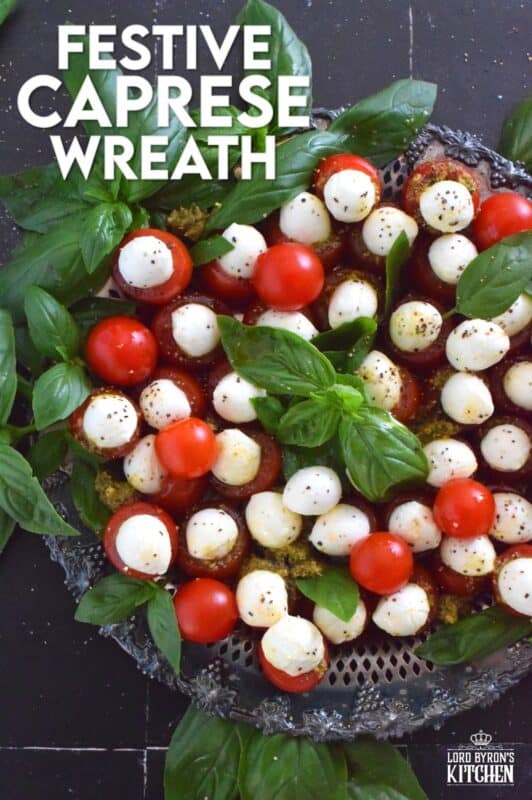 Simple, sweet, and cheesy!? You bet! This gorgeous Festive Caprese Wreath is easily prepared with hollowed-out cherry tomatoes stuffed with basil pesto and mini bocconcini. Sprinkle over some freshly ground black pepper, drizzle with olive oil, and tuck in some fresh basil leaves before serving! #festive #caprese #ediblewreath #tomatoes #bocconcini