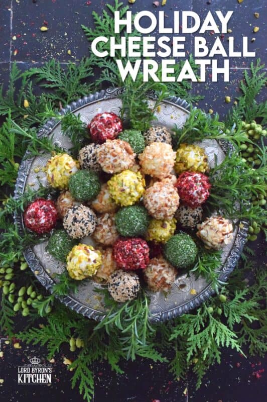 These little balls of cheese are rolled in a variety of toppings like toasted nuts and sesame seeds, dried herbs, and even some crushed pink peppercorns for some heat! A Holiday Cheese Ball Wreath is a great way to jazz up your snack table! Serve with your favourite crackers and some warm crostini! #christmas #holiday #appetizer #cheese #platter