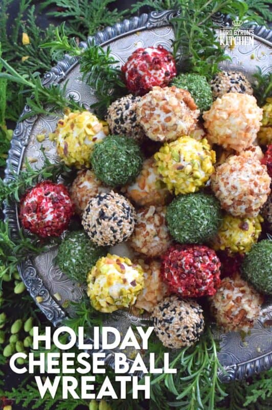 These little balls of cheese are rolled in a variety of toppings like toasted nuts and sesame seeds, dried herbs, and even some crushed pink peppercorns for some heat! A Holiday Cheese Ball Wreath is a great way to jazz up your snack table! Serve with your favourite crackers and some warm crostini! #christmas #holiday #appetizer #cheese #platter