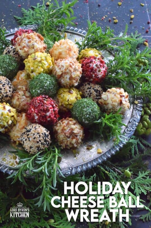 These little balls of cheese are rolled in a variety of toppings like toasted nuts and sesame seeds, dried herbs, and even some crushed pink peppercorns for some heat! A Holiday Cheese Ball Wreath is a great way to jazz up your snack table! Serve with your favourite crackers and some warm crostini! #christmas #holiday #appetizer #cheese #platter