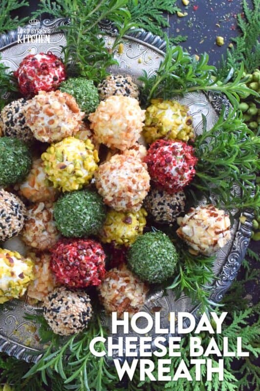 These little balls of cheese are rolled in a variety of toppings like toasted nuts and sesame seeds, dried herbs, and even some crushed pink peppercorns for some heat! A Holiday Cheese Ball Wreath is a great way to jazz up your snack table! Serve with your favourite crackers and some warm crostini! #christmas #holiday #appetizer #cheese #platter