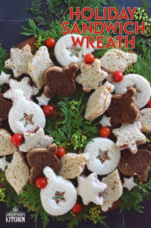 The sandwiches that make up this Holiday Sandwich Wreath are small, delicious, and festively shaped with your favourite cookie cutters. With four different flavours, there's one for everyone! Serve these finger sandwiches with a cup of hot tea at an afternoon holiday gathering! #sandwiches #fingerfoods #charcuterie #christmas #holiday #nobake