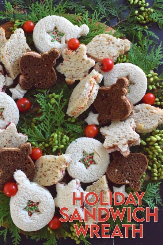 The sandwiches that make up this Holiday Sandwich Wreath are small, delicious, and festively shaped with your favourite cookie cutters. With four different flavours, there's one for everyone! Serve these finger sandwiches with a cup of hot tea at an afternoon holiday gathering! #sandwiches #fingerfoods #charcuterie #christmas #holiday #nobake