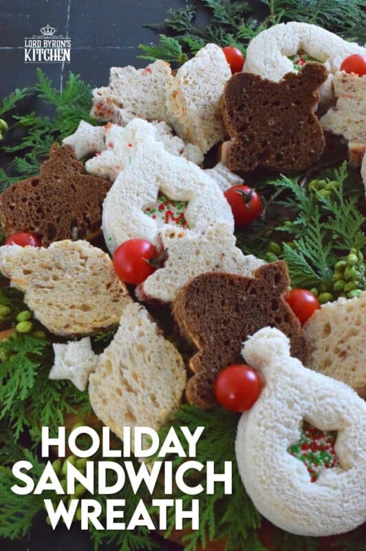 The sandwiches that make up this Holiday Sandwich Wreath are small, delicious, and festively shaped with your favourite cookie cutters. With four different flavours, there's one for everyone! Serve these finger sandwiches with a cup of hot tea at an afternoon holiday gathering! #sandwiches #fingerfoods #charcuterie #christmas #holiday #nobake