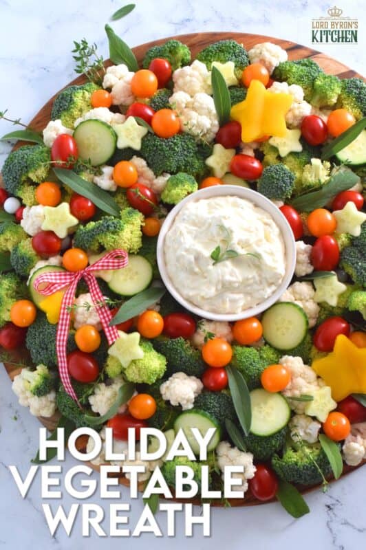 Every party needs a platter or two of finger foods for everyone to munch on. No matter what type of party you're hosting, it most certainly needs a Holiday Vegetable Wreath platter. This gorgeous wreath is prepared using fresh broccoli, cauliflower, tomatoes, cucumbers, and more! Serve with your favourite vegetable dip! #christmas #holiday #partyfood #appetizers #veggieplatter #veggies
