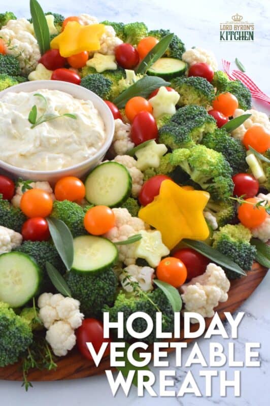 Every party needs a platter or two of finger foods for everyone to munch on. No matter what type of party you're hosting, it most certainly needs a Holiday Vegetable Wreath platter. This gorgeous wreath is prepared using fresh broccoli, cauliflower, tomatoes, cucumbers, and more! Serve with your favourite vegetable dip! #christmas #holiday #partyfood #appetizers #veggieplatter #veggies