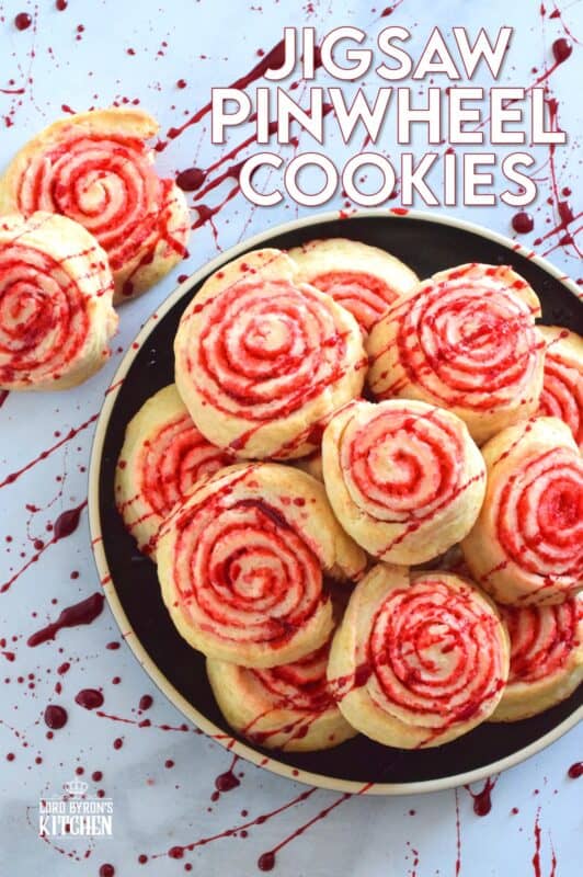 Despite their horror-ish name and their bloody demeanour, Jigsaw Pinwheel Cookies are a light and buttery delight! Liberally dusted with red sanding sugar, the biscuit-like dough is rolled to form the look of Jigsaw's red and white spirally cheeks. Complete with a splattering of homemade edible blood, these cookies are perfect for Halloween and the Saw franchise fan! #jigsaw #saw #sawmovie #halloween #cookies #edible #blood
