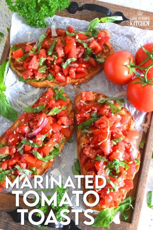 Summer fresh tomatoes are marinated with olive oil, garlic, red onions, and balsamic vinegar and piled high on garlic-rubbed grilled toast. Marinated Tomato Toasts are one of my favourite ways to use up my home-grown tomato harvest! #tomato #tomatoes #summerfresh #toasts #sourdough #bread #marinated