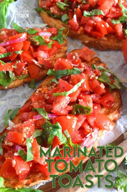 Summer fresh tomatoes are marinated with olive oil, garlic, red onions, and balsamic vinegar and piled high on garlic-rubbed grilled toast. Marinated Tomato Toasts are one of my favourite ways to use up my home-grown tomato harvest! #tomato #tomatoes #summerfresh #toasts #sourdough #bread #marinated