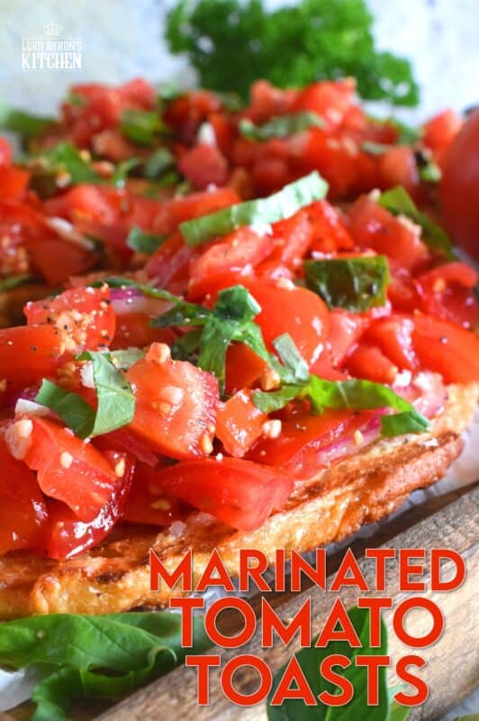 Summer fresh tomatoes are marinated with olive oil, garlic, red onions, and balsamic vinegar and piled high on garlic-rubbed grilled toast. Marinated Tomato Toasts are one of my favourite ways to use up my home-grown tomato harvest! #tomato #tomatoes #summerfresh #toasts #sourdough #bread #marinated