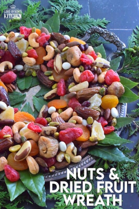 Christmastime is synonymous with nuts and fruits, so with that in mind, a Nuts and Dried Fruit Wreath was an obvious choice! No cooking or baking is necessary here! Assemble this beautiful, healthy snack wreath in very little time with a quick trip to your favourite bulk food supply store! #driedfruit #nuts #snacks #christmas #partyfoods #snackbowl