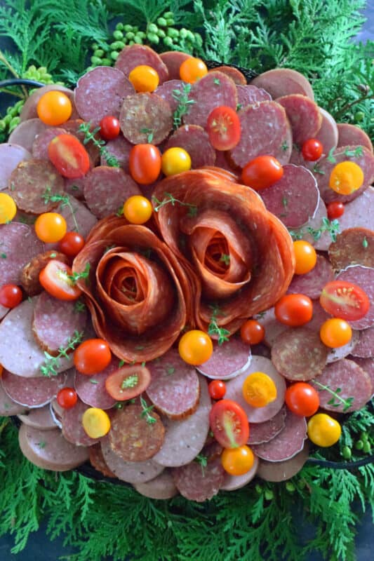 Every festive gathering needs to have a platter of deli-style meats to accompany the crackers, bread, pickles, and cheeses. This impressive Assorted Cured Meats Wreath is just what you need for your holiday buffet table. Prepared with pepperoni, salami, kielbasa, and more, this wreath is for all of the carnivores in your life! #wreath #christmas #holiday #charcuterie