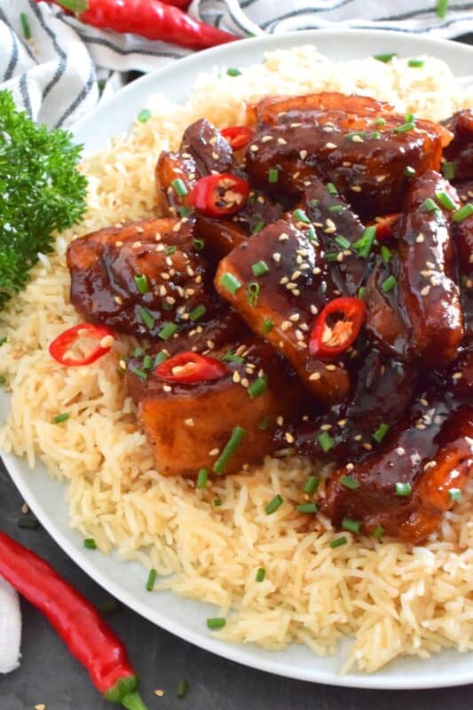 Prepared in a braising liquid consisting of brown sugar, pineapple juice, dried chilies, and soy sauce, Filipino-inspired Braised Pork Hamonado is the most satisfying and tasty pork dish. It is sweet, savoury, salty, and spicy, which is everything one could ever want in a pork belly recipe! #porkbelly #hamonado #asian #filipino #pork #braised
