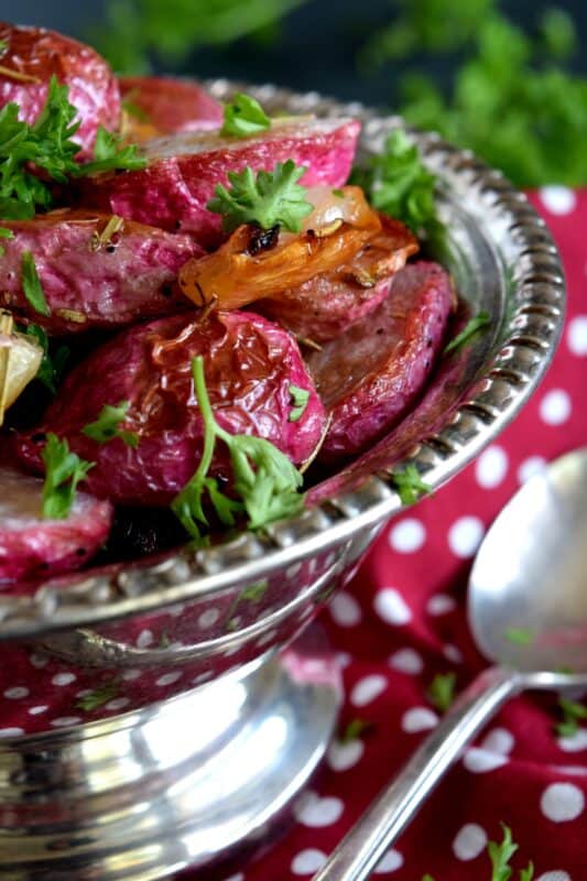If you've never had a roasted radish, you're in for a treat! Rosemary Roasted Radishes are mellow in flavour, gorgeous in colour, easy to make, and low in carbs. Healthy, delicious, and cheap; this side dish is sure to please and surprise! #roastedvegetables #radishes #roastedradishes #rootvegetables #sidedishes #thanksgiving