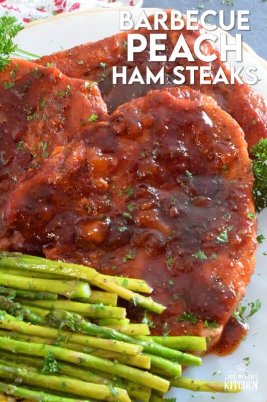 The combination of a sweet and smoky barbecue sauce with jarred peach preserves is the perfect addition to accompany these oven-baked ham steaks. Add some garlic, onion, and a little ground black pepper to round out the flavours and you've got a very delicious family-style recipe for tonight's dinner! #ham #hamsteak #peach #bbq #bakedham