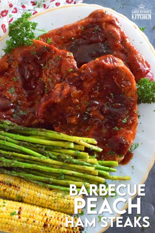 The combination of a sweet and smoky barbecue sauce with jarred peach preserves is the perfect addition to accompany these oven-baked ham steaks. Add some garlic, onion, and a little ground black pepper to round out the flavours and you've got a very delicious family-style recipe for tonight's dinner! #ham #hamsteak #peach #bbq #bakedham