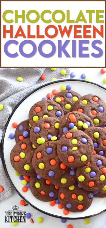 Chocolate Halloween Cookies have a slightly crispy exterior with a dense chocolaty center. Stuffed with white chocolate chips and topped with green, purple, and orange M&M candy, these cookies are both delicious and festive!  Your little trick-or-treaters are going to love these! #m&m #halloween #cookies #chocolate #trickortreat