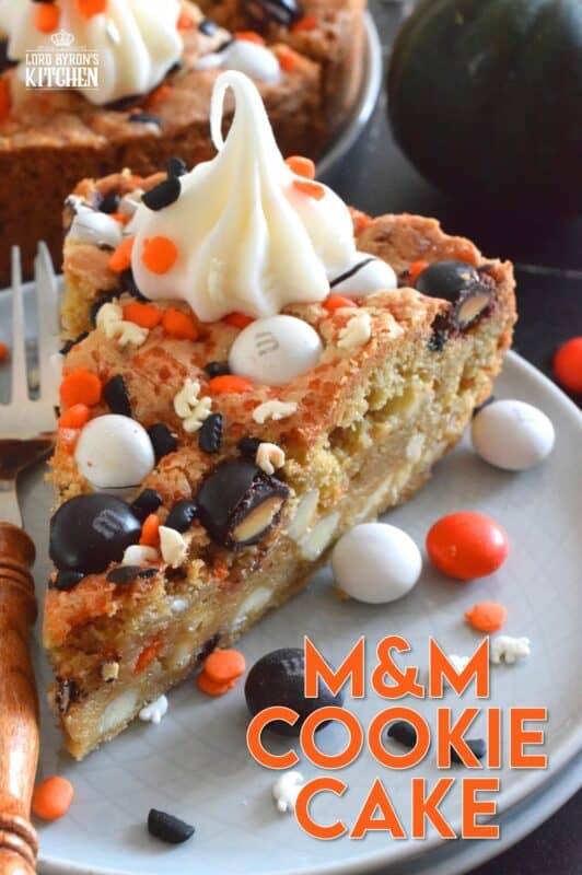 One giant cookie that eats like a cake, this M&M Cookie Cake is perfect when served with a dollop of frosting on each slice. Loaded with candy-coated chocolate and autumn sprinkles, this cake is a fun dessert the whole family will love! #M&M #halloween #cookie #cake #chocolate