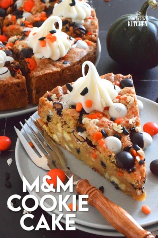 One giant cookie that eats like a cake, this M&M Cookie Cake is perfect when served with a dollop of frosting on each slice. Loaded with candy-coated chocolate and autumn sprinkles, this cake is a fun dessert the whole family will love! #M&M #halloween #cookie #cake #chocolate