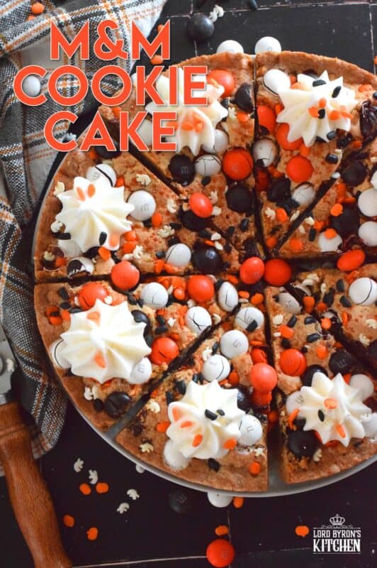 One giant cookie that eats like a cake, this M&M Cookie Cake is perfect when served with a dollop of frosting on each slice. Loaded with candy-coated chocolate and autumn sprinkles, this cake is a fun dessert the whole family will love! #M&M #halloween #cookie #cake #chocolate