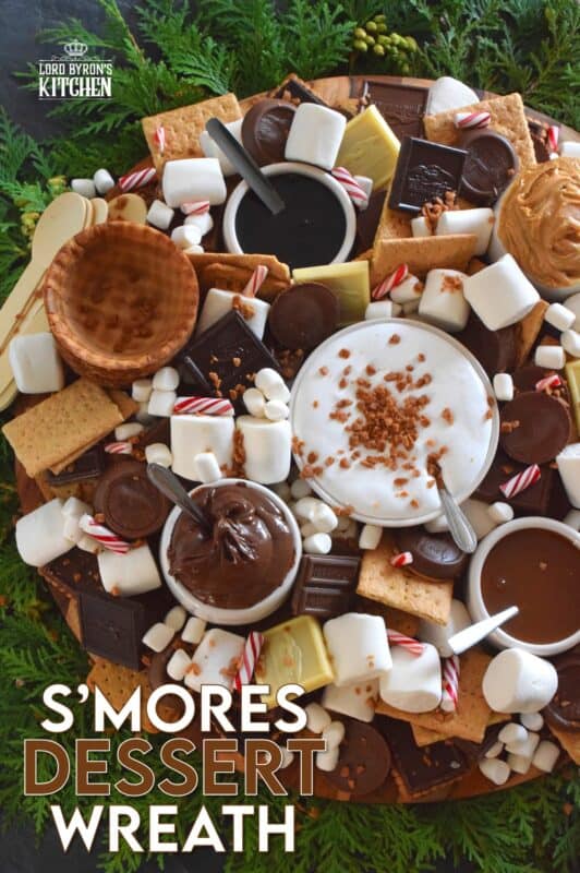 The ultimate rich and indulgent treat can be summed up in three words - S'mores Dessert Wreath! Assemble all of the ingredients into a large wreath and set it out for your guests. Utilizing marshmallow fluff will mimic the gooey marshmallow effect everyone craves, but you can make s'mores more authentic by roasting the marshmallows using your fireplace or even a candle! #smores #christmas #holiday #dessertbar