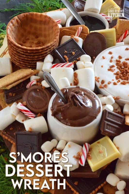 The ultimate rich and indulgent treat can be summed up in three words - S'mores Dessert Wreath! Assemble all of the ingredients into a large wreath and set it out for your guests. Utilizing marshmallow fluff will mimic the gooey marshmallow effect everyone craves, but you can make s'mores more authentic by roasting the marshmallows using your fireplace or even a candle! #smores #christmas #holiday #dessertbar