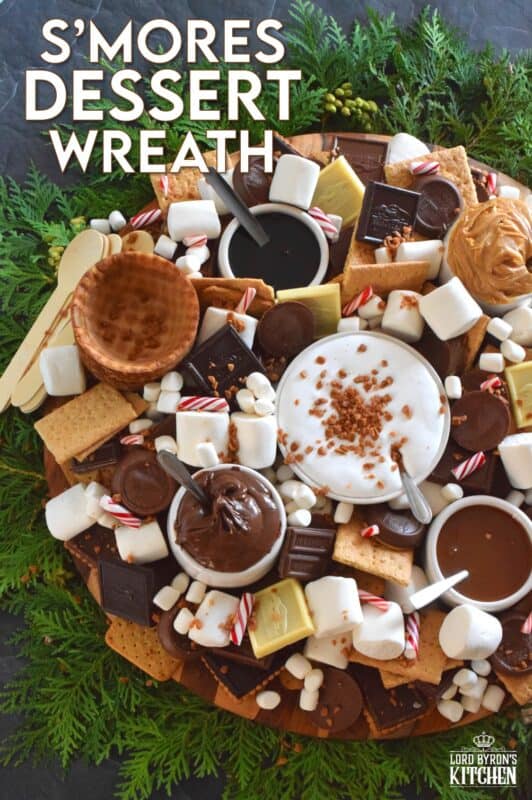 The ultimate rich and indulgent treat can be summed up in three words - S'mores Dessert Wreath! Assemble all of the ingredients into a large wreath and set it out for your guests. Utilizing marshmallow fluff will mimic the gooey marshmallow effect everyone craves, but you can make s'mores more authentic by roasting the marshmallows using your fireplace or even a candle! #smores #christmas #holiday #dessertbar