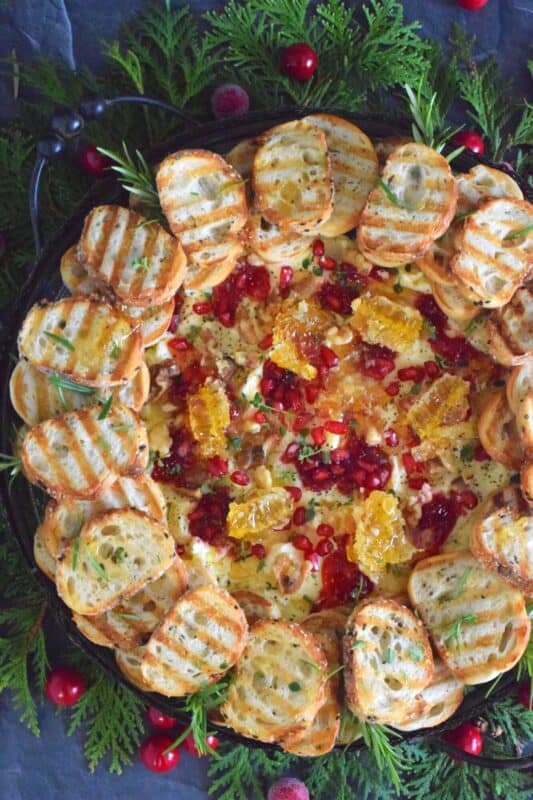 Just like charcuterie boards have become super popular, butter boards are about to become the next trending appetizer.  Serve grilled bread or crackers with a Butter Board Wreath to your guests this holiday season. With a Christmas-inspired flavour profile, everyone is going to love this fun and festive treat! #butter #board #butterboard #wreath #appetizer #christmas