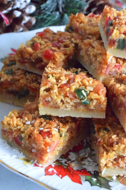 A quick and easy sweet treat which can be made almost entirely with items you already have in your pantry. Coconut Mixed Peel Squares have a simple shortbread-like base, and are topped with a sweet, chewy topping consisting of an Old English fruit cake mix. These squares are where fruitcake and shortbread marry to create the most delicious confection! #coconut #mixedpeel #fruitcake #christmas #holiday #baking