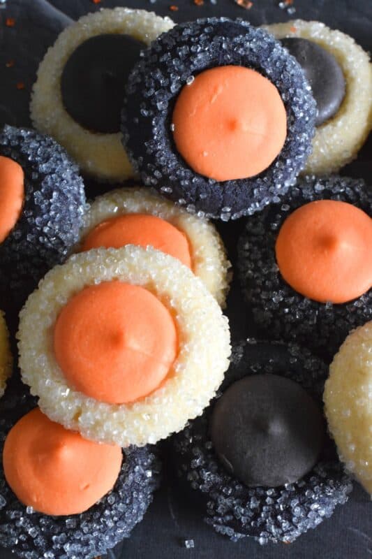 Similar to a classic thumbprint cookie, these Halloween Candy Melt Cookies use candy melts instead of jam. The cookie dough is tinted with food colouring and rolled in sanding sugar, these are all treat and no trick! #halloween #trickortreat #halloweencookies #candymelts #thumbprint