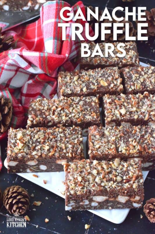 If you're looking for a holiday treat that is both super rich and decadent, Ganache Truffle Bars are just the answer! Marshmallows, toasted pecans, and coconut smothered in a chocolate truffle base is topped with a thick, creamy ganache and more pecans; this luscious and delectable treat is the ultimate Christmas dessert! #truffles #ganache #bars #squares #nuts #marshmallows