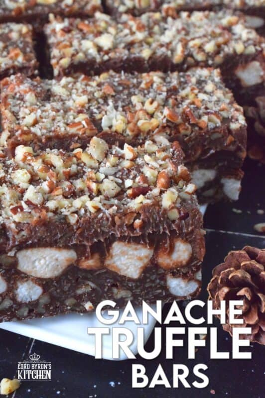 If you're looking for a holiday treat that is both super rich and decadent, Ganache Truffle Bars are just the answer! Marshmallows, toasted pecans, and coconut smothered in a chocolate truffle base is topped with a thick, creamy ganache and more pecans; this luscious and delectable treat is the ultimate Christmas dessert! #truffles #ganache #bars #squares #nuts #marshmallows
