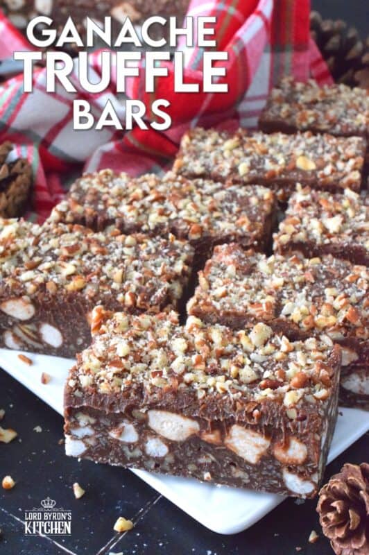 If you're looking for a holiday treat that is both super rich and decadent, Ganache Truffle Bars are just the answer! Marshmallows, toasted pecans, and coconut smothered in a chocolate truffle base is topped with a thick, creamy ganache and more pecans; this luscious and delectable treat is the ultimate Christmas dessert! #truffles #ganache #bars #squares #nuts #marshmallows