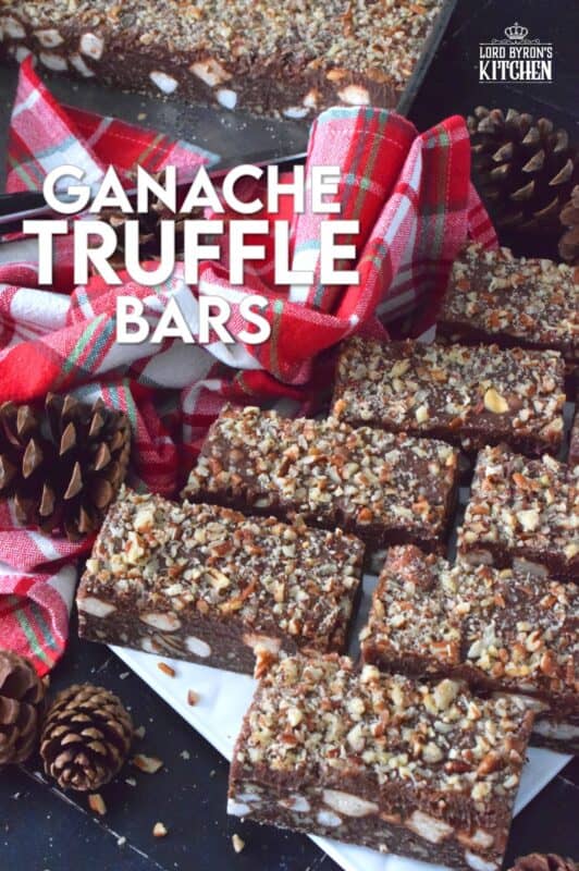If you're looking for a holiday treat that is both super rich and decadent, Ganache Truffle Bars are just the answer! Marshmallows, toasted pecans, and coconut smothered in a chocolate truffle base is topped with a thick, creamy ganache and more pecans; this luscious and delectable treat is the ultimate Christmas dessert! #truffles #ganache #bars #squares #nuts #marshmallows