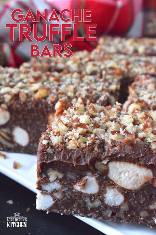 If you're looking for a holiday treat that is both super rich and decadent, Ganache Truffle Bars are just the answer! Marshmallows, toasted pecans, and coconut smothered in a chocolate truffle base is topped with a thick, creamy ganache and more pecans; this luscious and delectable treat is the ultimate Christmas dessert! #truffles #ganache #bars #squares #nuts #marshmallows