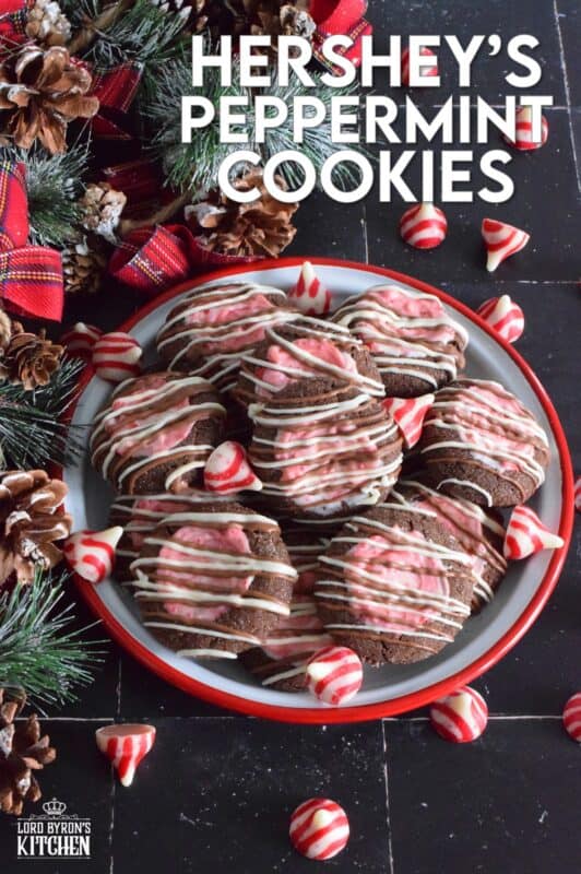 These soft chocolaty Hershey's Peppermint Cookies are baked and then topped with a peppermint kiss as soon as they come out of the oven. Once softened, the kiss is swirled to cover the top of the cookie and then drizzled with melted white chocolate. #peppermint #hershey #kisses #cookies #christmas