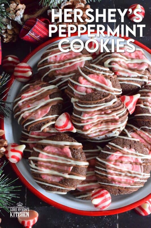 These soft chocolaty Hershey's Peppermint Cookies are baked and then topped with a peppermint kiss as soon as they come out of the oven. Once softened, the kiss is swirled to cover the top of the cookie and then drizzled with melted white chocolate. #peppermint #hershey #kisses #cookies #christmas