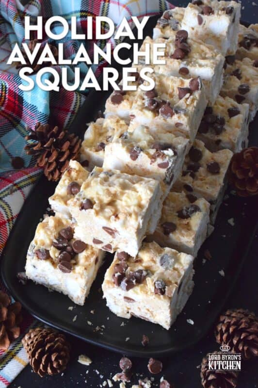 These no-bake treats are prepared with lots of white chocolate, creamy peanut butter, a few cups of rice cereal, and a good helping of marshmallows too. Holiday Avalanche Squares are absolutely delicious! The white chocolate is melted together with the peanut butter, and once cooled, the other ingredients are folded in to create these wonderfully high and cloudy-soft squares! #squares #bars #nobake #christmas #holiday #baking #cookies #chocolate