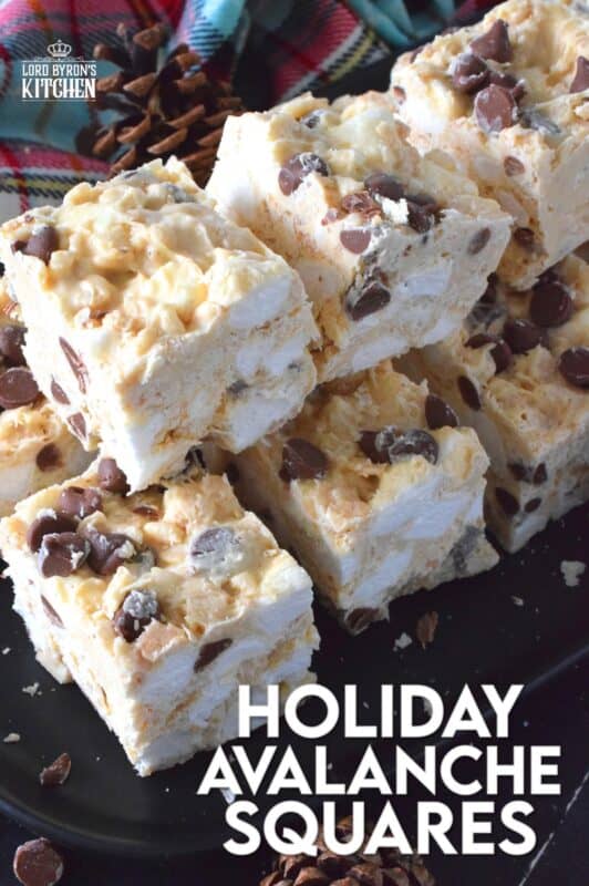 These no-bake treats are prepared with lots of white chocolate, creamy peanut butter, a few cups of rice cereal, and a good helping of marshmallows too. Holiday Avalanche Squares are absolutely delicious! The white chocolate is melted together with the peanut butter, and once cooled, the other ingredients are folded in to create these wonderfully high and cloudy-soft squares! #squares #bars #nobake #christmas #holiday #baking #cookies #chocolate