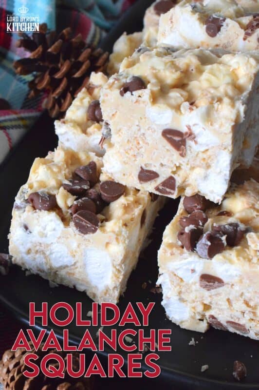 These no-bake treats are prepared with lots of white chocolate, creamy peanut butter, a few cups of rice cereal, and a good helping of marshmallows too. Holiday Avalanche Squares are absolutely delicious! The white chocolate is melted together with the peanut butter, and once cooled, the other ingredients are folded in to create these wonderfully high and cloudy-soft squares! #squares #bars #nobake #christmas #holiday #baking #cookies #chocolate
