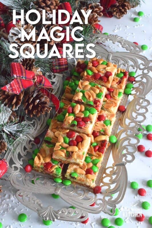 This multi-layered sweet treat is perfect for the holidays! Not only is it fast and easy, but it's also relatively inexpensive too! Prepared with white chocolate, salted peanuts, coconut, and M&Ms, these Holiday Magic Squares are gooey and messy, and absolutely worth it! #holiday #M&M #magicbars #squares #eaglebrand