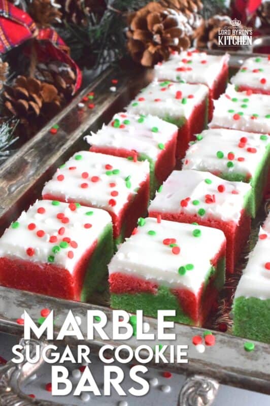 These pillow-soft, beautifully festive red and green Marble Sugar Cookie Bars are going to be on everyone's wishlist this Christmas! The cookie base is buttery and sweet with a light fruity note and topped with a homemade buttercream frosting. One should not question if they will make these; only question whether you will call them bars, squares, cookies, or even cake! #sugarcookies #bars #squares #christmas #holiday #baking #marble #redandgreen