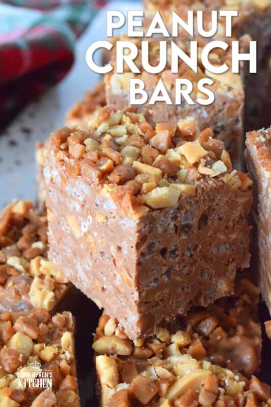 These no-bake bars are super delicious! Prepared with both milk chocolate chips and peanut butter chips, these Peanut Crunch Bars are loaded with crispy rice cereal, toffee bits, and chopped, salted peanuts too! Who needs store-bought treats when you can whip up a batch of these in mere minutes!? #peanutbutter #crunchbars #peanuts #chocolate #nobake #christmas #holiday #bars #squares