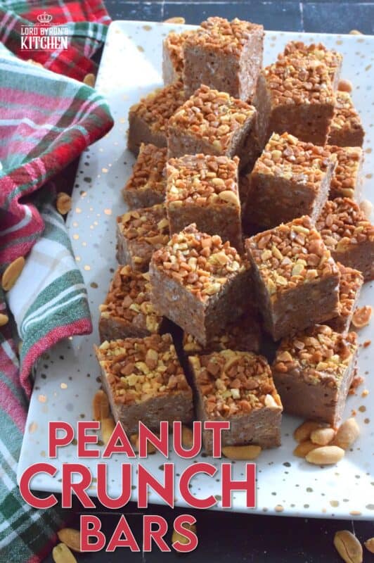 These no-bake bars are super delicious! Prepared with both milk chocolate chips and peanut butter chips, these Peanut Crunch Bars are loaded with crispy rice cereal, toffee bits, and chopped, salted peanuts too! Who needs store-bought treats when you can whip up a batch of these in mere minutes!? #peanutbutter #crunchbars #peanuts #chocolate #nobake #christmas #holiday #bars #squares