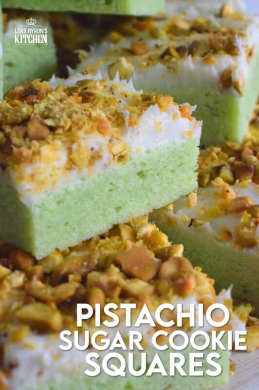 The uncomplicated and delicious sugar cookie gets a fresh, new flavour profile, and an upgrade in this Pistachio Sugar Cookie Squares recipe.  The classic sugar cookie base is pistachio flavoured and prepared with boxed pistachio pudding powder.  Topped with a layer of delicious buttercream frosting and sprinkled with roasted, salted chopped pistachios, this cookie is simply irresistible! #pistachio #sugarcookies #cookies #christmas #holiday #squares #baking