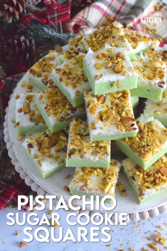 The uncomplicated and delicious sugar cookie gets a fresh, new flavour profile, and an upgrade in this Pistachio Sugar Cookie Squares recipe.  The classic sugar cookie base is pistachio flavoured and prepared with boxed pistachio pudding powder.  Topped with a layer of delicious buttercream frosting and sprinkled with roasted, salted chopped pistachios, this cookie is simply irresistible! #pistachio #sugarcookies #cookies #christmas #holiday #squares #baking