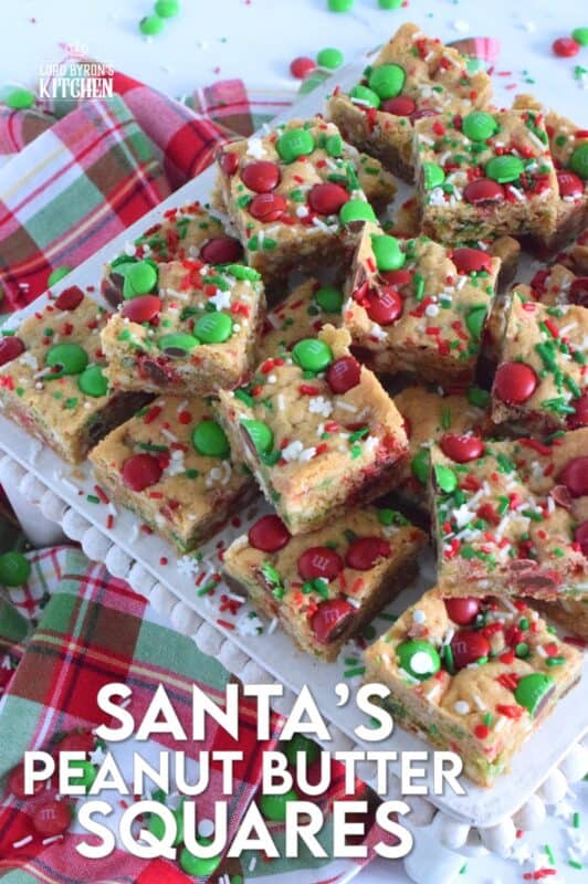 If you want extra presents under the tree this year, leave a couple of these Santa's Peanut Butter Squares with a tall glass of milk on the mantle this Christmas Eve! Loaded with sprinkles, M&Ms, white chocolate chips, peanut butter, and more, who wouldn't want to sink their teeth into this festive treat!? #holidaybars #m&ms #cookies #christmas #baking