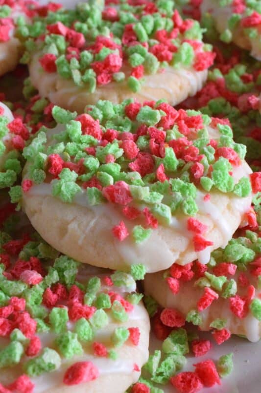 Elf on the Shelf Cereal Cookies are prepared with a delicious sugar cookie base which has finely crushed cereal incorporated into the batter. Next, the cookies are glazed and topped with lots of broken cereal bits. These cookies are super crunchy and super flavourful! #elfontheshelf #sugarcookies #cereal