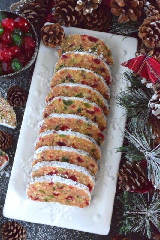 This no-bake holiday confection is prepared with both red and green candied cherries, sweetened condensed milk, toasted walnuts, and crushed vanilla wafers.  These are humble ingredients, but Candied Cherry Slices are impressively delicious and decadent! #cherries #nobake #christmas #candied #redandgreen